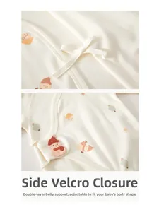 Detail of baby romper featuring side velcro closure and cute snowman pattern print