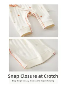 Detail of crotch snaps on newborn cotton romper for easy diaper changes and dressing