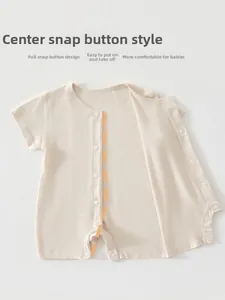 Detail view of the snap button closure on a breathable short sleeve baby romper