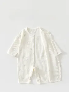 Detailed view of the snap-button closure on this cotton white baby bear romper