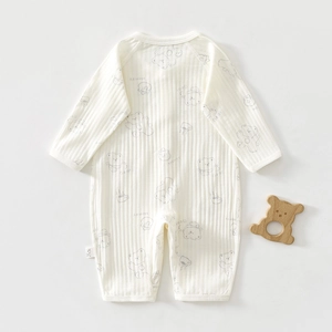 Detail of soft ribbed cotton baby romper with cute bear and honey jar print
