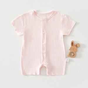 Close-up of soft pink baby romper with snap buttons and clear fabric texture detail