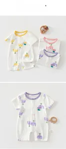 Detail of cotton baby rompers with floral prints and snap buttons in various colors