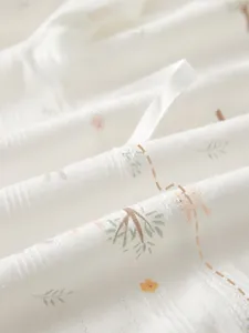 Detail of four-needle six-thread seamless stitching on breathable newborn baby romper fabric