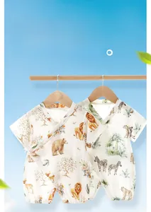 Detail of bamboo cotton baby romper with zoo animal prints and side tie-up closure