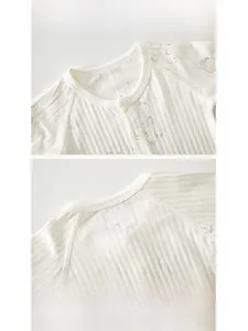 Close-up of baby bodysuit neckline with ribbed cotton fabric and cute bear print