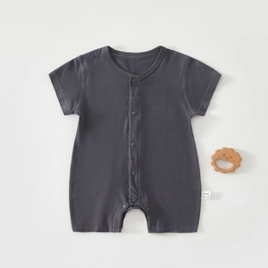 Detail of grey baby short-sleeve romper showing fabric texture and wooden teether