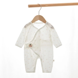 Macro shot of breathable newborn romper with delicate floral print and cherry embroidery