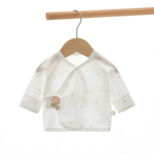 Detail of newborn baby cotton kimono top with pink floral print and lace-up closure