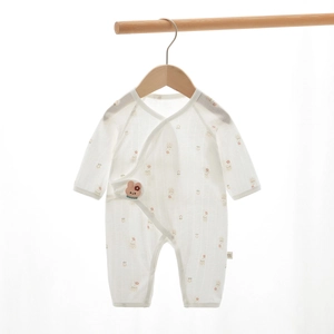 Detail of newborn baby cotton romper with floral prints and side-tie kimono closure