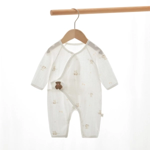 Detail of soft cotton baby romper with bear print and side-tie belly protection