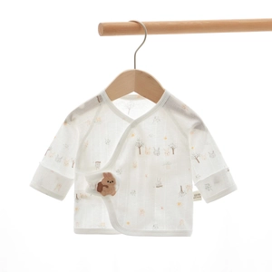 Detail of 100% cotton newborn baby shirt featuring animal prints and a rabbit patch