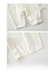 Detailed view of the bottom snap buttons on baby striped cotton jumpsuit for easy diapering