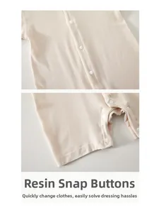 Detailed close-up of smooth resin snap buttons on a breathable baby cotton romper jumpsuit