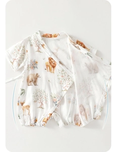 Detail of baby summer romper featuring soft breathable cotton fabric and forest animal print
