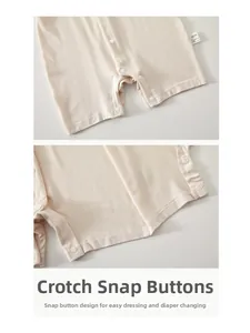 Detail of baby romper snap fasteners on crotch for easy diaper changes and dressing