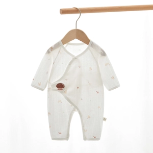 Detail of soft cotton newborn romper with mushroom print and side snap closure