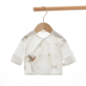 Detail of 100% cotton baby kimono wrap top with seal animal print and size label