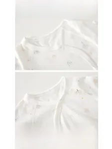 Detail of newborn baby romper with cotton fabric, featuring snap closure and ribbing neckline