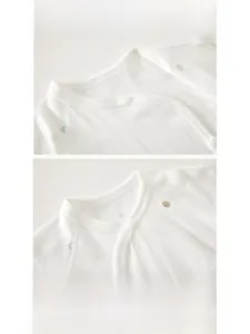 Close-up of pure cotton baby undershirt with jacquard texture and snap button neckline