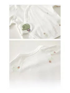 Detail of baby cotton top with elephant print and breathable jacquard texture
