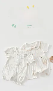 Detail of baby rompers in bamboo fiber fabric featuring floral and bunny prints