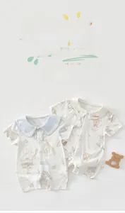 Detail of baby summer bodysuit featuring breathable bamboo cotton fabric and cute animal prints
