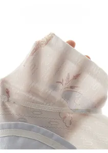 Detail shot of breathable baby bamboo cotton fabric with floral pattern showing light texture