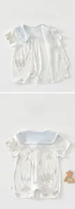 Detail of baby cotton bodysuit featuring blue sailor collar and cute giraffe prints