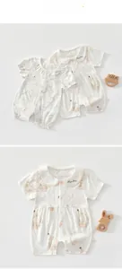 Detailed close-up of breathable baby romper fabric with cute rabbit print and floral collar