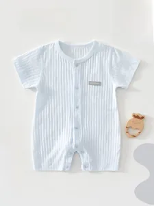 Close-up of light blue baby bodysuit with vertical striped texture and wood toy