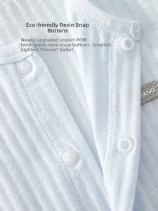 Detail of baby bodysuit showing food-grade resin snap buttons on soft ribbed fabric