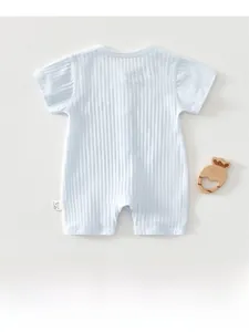 Detailed view of light blue ribbed cotton baby romper with soft texture and wooden toy