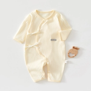 Close-up of light yellow rib-knit baby bodysuit with side tie and snap buttons
