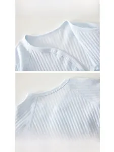 Detail of the soft ribbed cotton collar with reinforced edging on a blue infant bodysuit