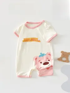 Close-up of cotton baby bodysuit with pink trim and cute pink bear illustration