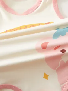 Close-up of soft cotton baby bodysuit featuring pink bear print and Lovely text