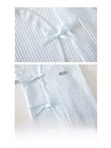 Detail of light blue ribbed cotton baby romper featuring side-tie and double-layer belly guard