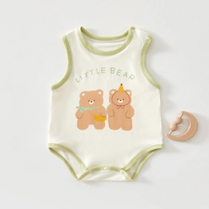 Detail of baby cotton bodysuit featuring cute cartoon bears and green piping accents