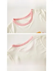 Detail view of baby cotton bodysuit neckline with soft ribbing and shoulder snaps