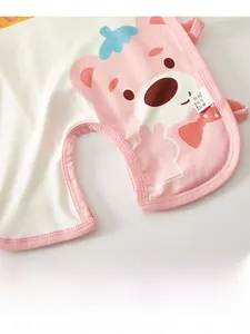 Close-up of cotton baby bodysuit fabric with pink bear print and side washing label