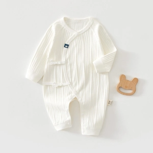 Detail of newborn ribbed cotton romper with side-tie closure and crown logo embroidery