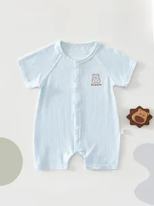 Close-up of light blue newborn baby romper with hi bear embroidery and snap buttons