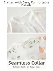 Detail of baby cotton top featuring peach print and smooth hemmed neckline with snaps