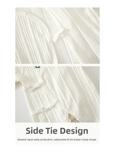 Detail of newborn cotton bodysuit featuring side-tie closure and double layer belly protection