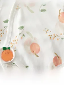 Detail of soft cotton baby shirt featuring peach prints and 3D applique embroidery