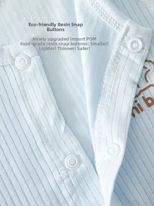 Close-up of light blue baby bodysuit with white snap buttons and soft ribbed fabric texture