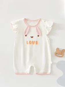 Detail of baby summer romper featuring cute rabbit face, 3D ears, and snap fasteners