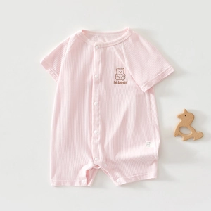 Close-up of pink baby romper with bear embroidery and ribbed fabric texture