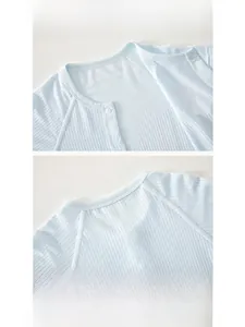 Detail of baby light blue ribbed bodysuit featuring a soft hemmed neckline and resin buttons